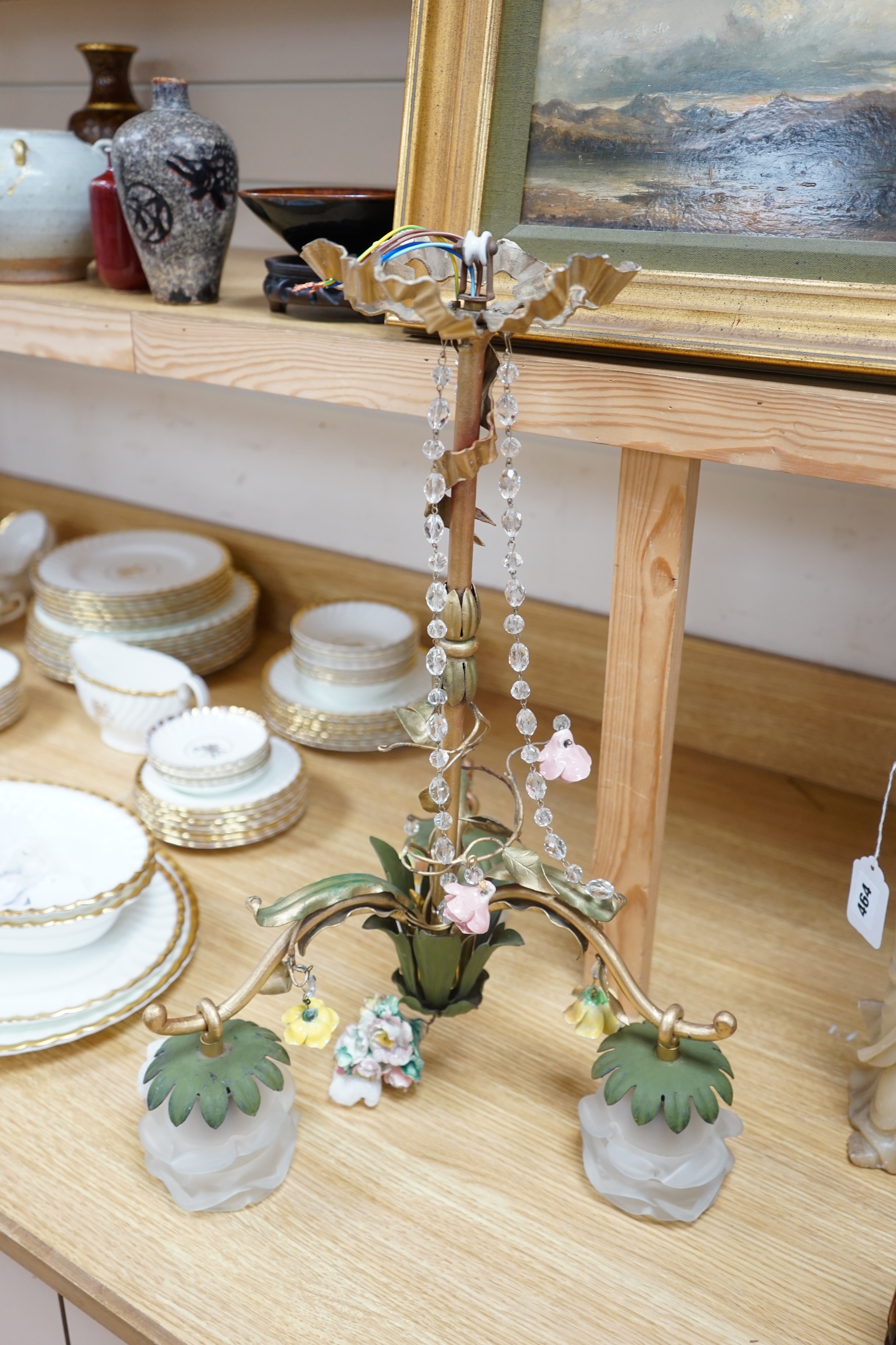 A French three arm coloured wrought iron ceiling light with frosted petal shades and porcelain flower decoration, circa 1930’s, 57cm high, 36cm across. Condition - fair